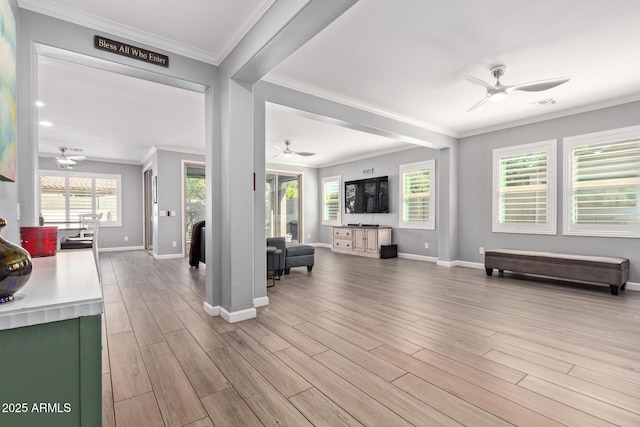 living area with visible vents, a healthy amount of sunlight, a ceiling fan, and wood finished floors