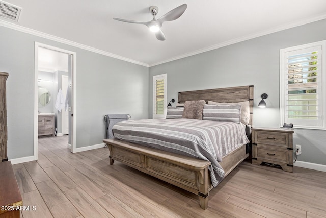 bedroom featuring baseboards, visible vents, light wood finished floors, and ornamental molding