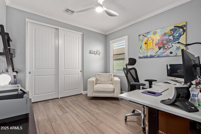 office space with visible vents, wood finished floors, a ceiling fan, and ornamental molding