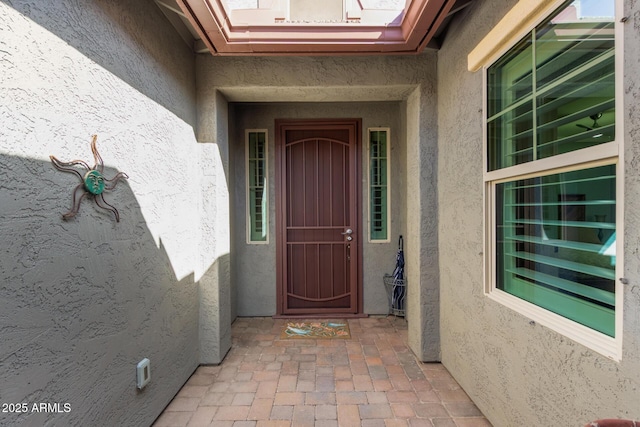 property entrance with stucco siding