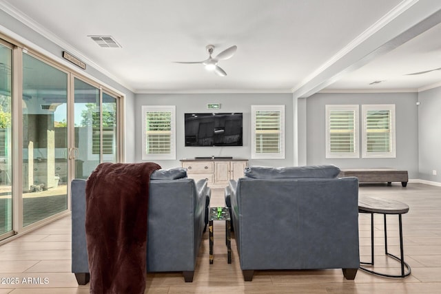 living room with light wood-type flooring, visible vents, ornamental molding, and a ceiling fan