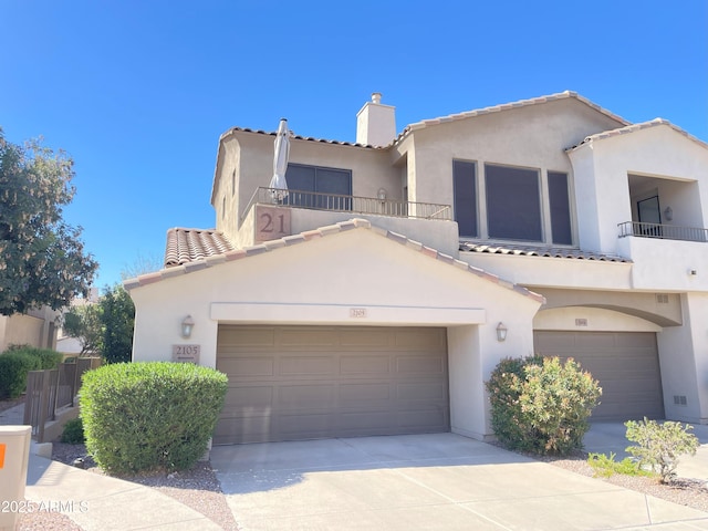 mediterranean / spanish-style home featuring a balcony, driveway, and stucco siding