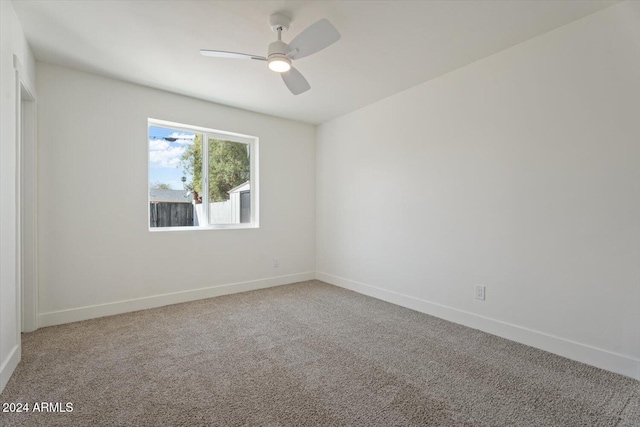 spare room with carpet and ceiling fan