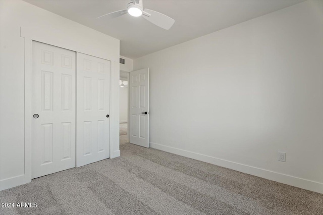 unfurnished bedroom with carpet floors, a closet, and ceiling fan