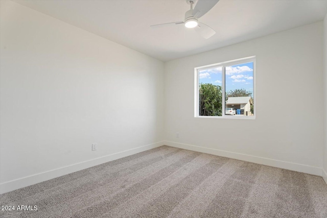 empty room with ceiling fan and carpet