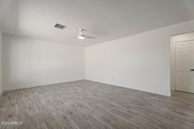 empty room with light hardwood / wood-style floors and ceiling fan