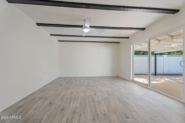 empty room featuring light hardwood / wood-style flooring, beamed ceiling, and ceiling fan