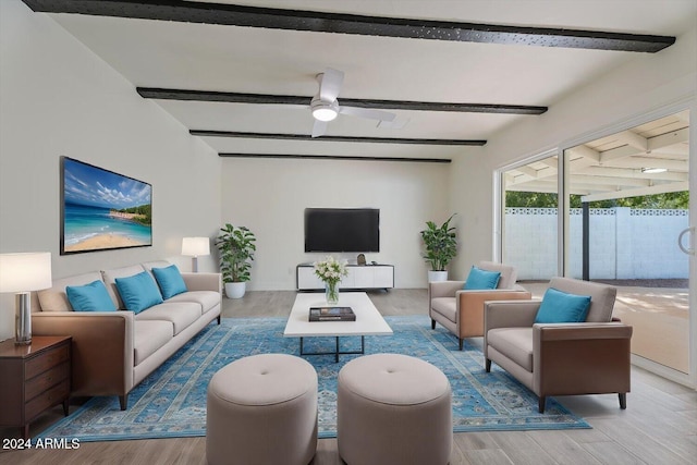 living room featuring beam ceiling, wood-type flooring, and ceiling fan