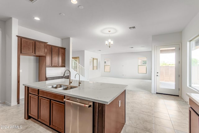 8628 W Solano Dr, Glendale, AZ 85305 - kitchen featuring a sink, dishwasher, light stone counters, open floor plan, and a center island with sink