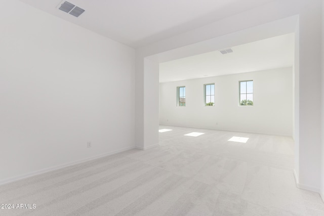 unfurnished room with light carpet