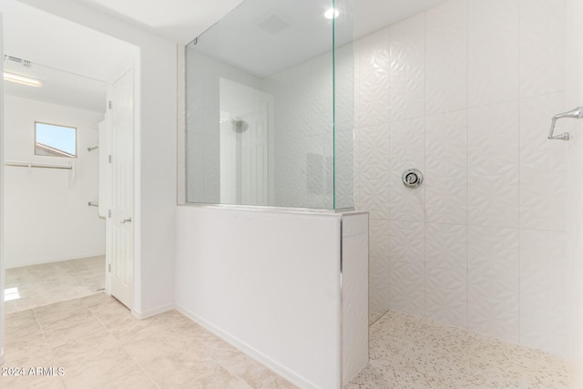 bathroom with tiled shower