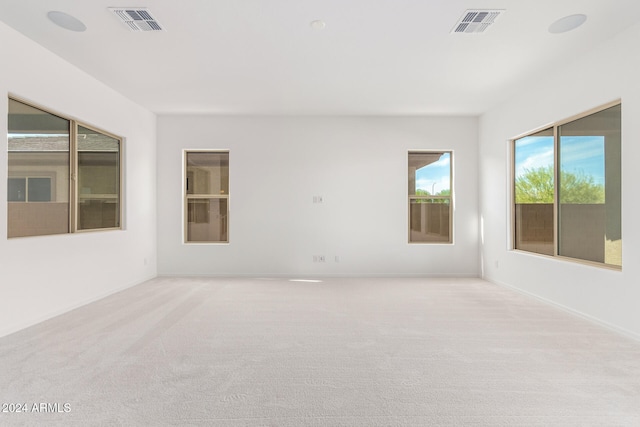 unfurnished room featuring light colored carpet