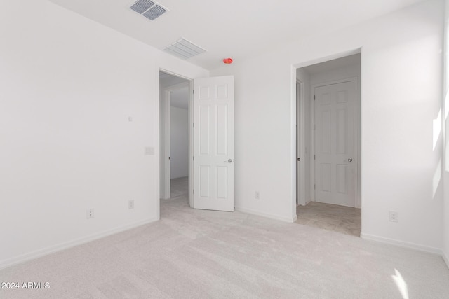 unfurnished bedroom with light carpet