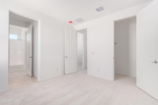 unfurnished bedroom featuring light colored carpet