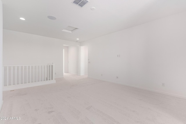 8628 W Solano Dr, Glendale, AZ 85305 - spare room with light colored carpet, recessed lighting, attic access, and baseboards