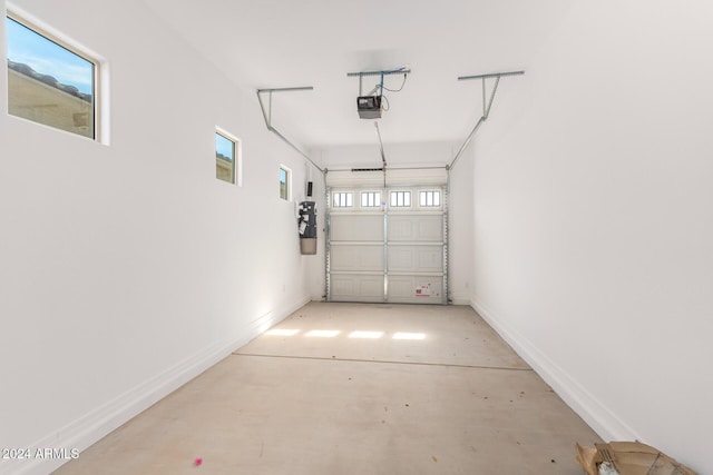 8628 W Solano Dr, Glendale, AZ 85305 - garage with a garage door opener, a central vacuum unit, and baseboards