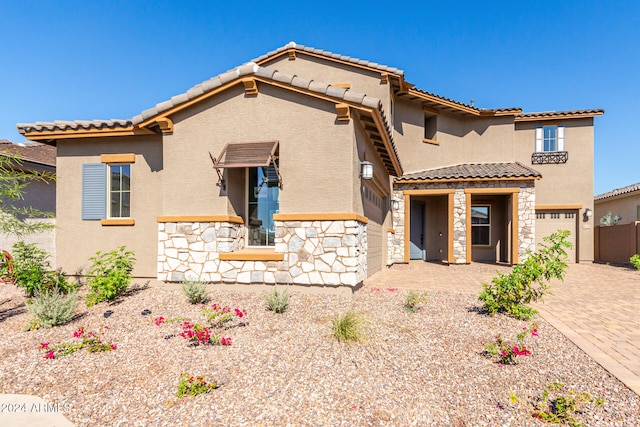 mediterranean / spanish-style house featuring a garage