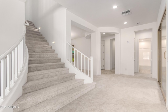 8628 W Solano Dr, Glendale, AZ 85305 - stairs with arched walkways, recessed lighting, and carpet flooring