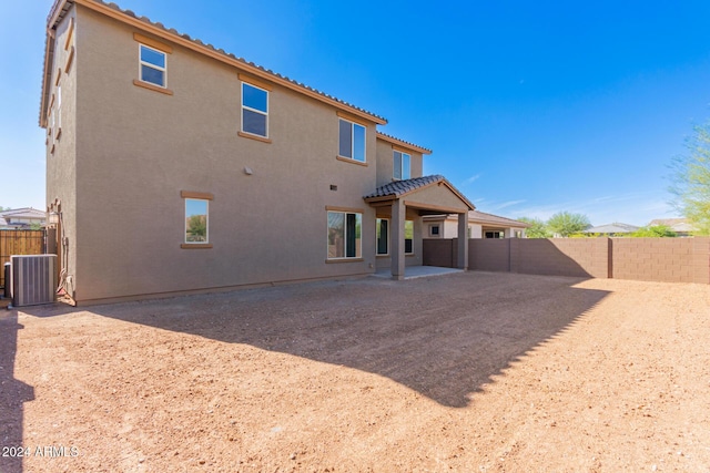 8628 W Solano Dr, Glendale, AZ 85305 - rear view of house featuring stucco siding, central air condition unit, a fenced backyard, and a patio area