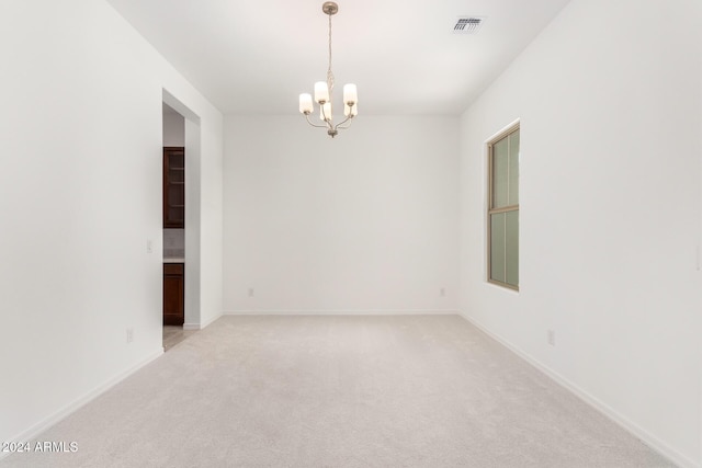 8628 W Solano Dr, Glendale, AZ 85305 - empty room with a chandelier, light carpet, and baseboards