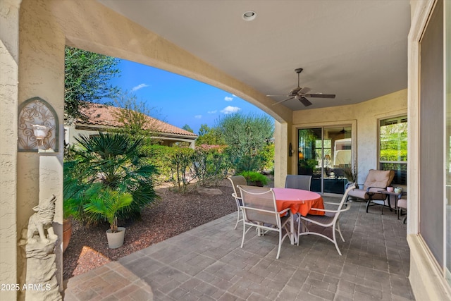 view of patio featuring outdoor dining space and a ceiling fan