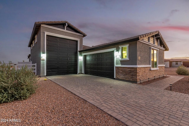 property exterior at dusk with a garage