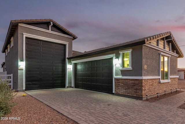 view of garage at dusk