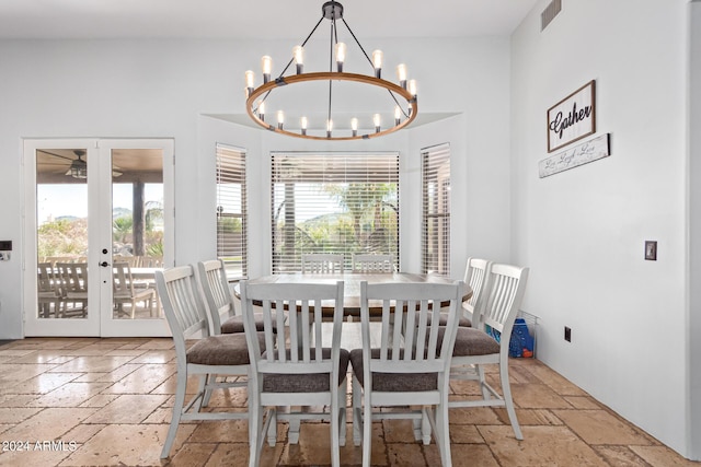 2731 W Desert Ranch Rd, Phoenix, AZ 85086 - dining room featuring stone tile floors, a chandelier, french doors, and ceiling fan