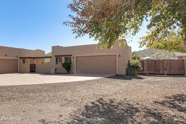 2731 W Desert Ranch Rd, Phoenix, AZ 85086 - adobe home with concrete driveway, an attached garage, and stucco siding