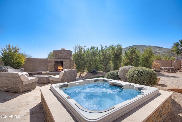 2731 W Desert Ranch Rd, Phoenix, AZ 85086 - view of swimming pool with an outdoor stone fireplace, an outdoor hot tub, a patio area, and a mountain view