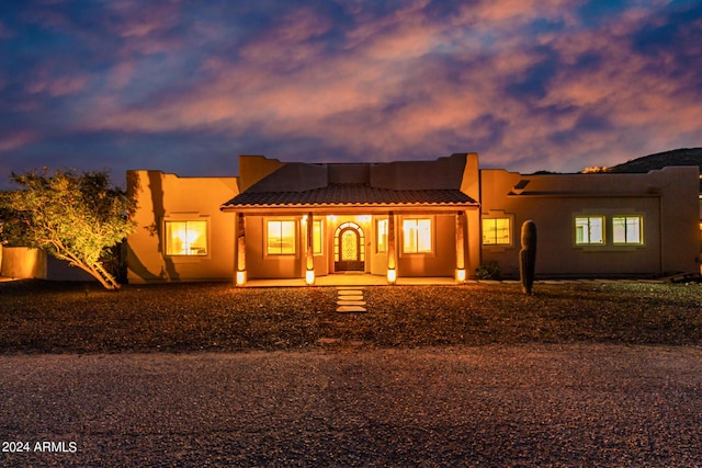 2731 W Desert Ranch Rd, Phoenix, AZ 85086 - pueblo-style house featuring a tile roof, stucco siding, and a porch