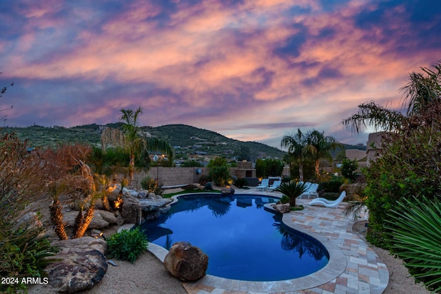 2731 W Desert Ranch Rd, Phoenix, AZ 85086 - pool at dusk with a mountain view and a patio