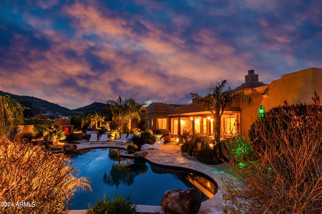 2731 W Desert Ranch Rd, Phoenix, AZ 85086 - pool at dusk with a patio, an outdoor pool, and a mountain view
