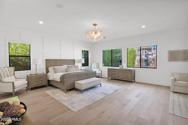 bedroom with a notable chandelier and light hardwood / wood-style floors