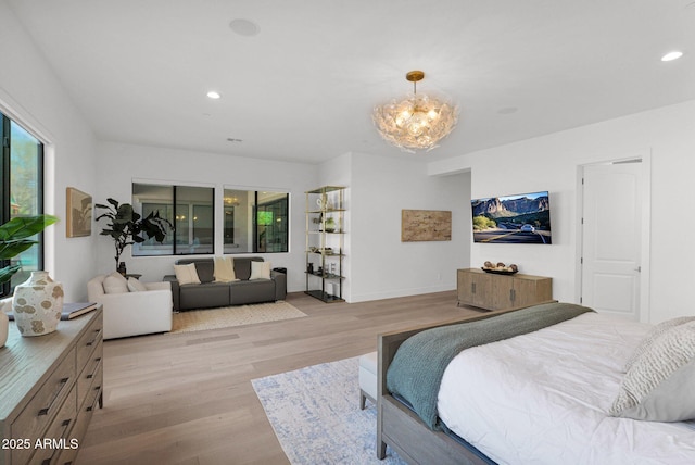 bedroom featuring a chandelier and light hardwood / wood-style floors