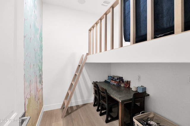 stairway with hardwood / wood-style flooring