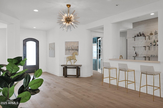 entryway with an inviting chandelier and light hardwood / wood-style floors