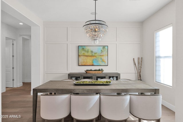 dining space featuring an inviting chandelier and hardwood / wood-style floors