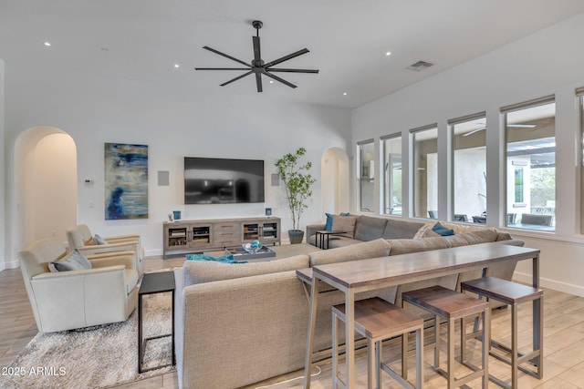 10886 N 137th St, Scottsdale, AZ 85259 - living area with visible vents, baseboards, light wood-type flooring, arched walkways, and a ceiling fan
