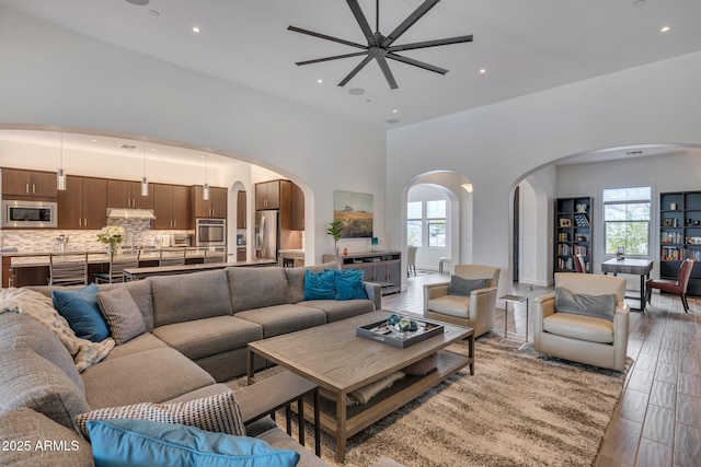 10886 N 137th St, Scottsdale, AZ 85259 - living area with recessed lighting, arched walkways, light wood-style floors, and ceiling fan
