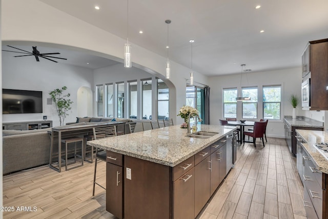 10886 N 137th St, Scottsdale, AZ 85259 - kitchen featuring a sink, open floor plan, ceiling fan, and wood tiled floor