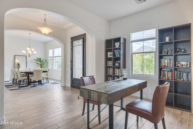 10886 N 137th St, Scottsdale, AZ 85259 - dining area with arched walkways, plenty of natural light, light wood-style flooring, and visible vents