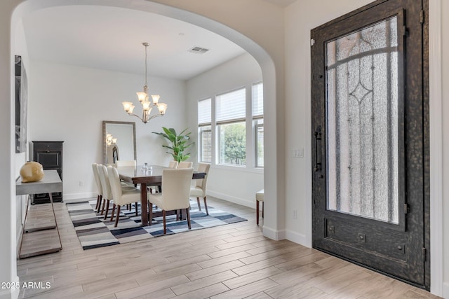 10886 N 137th St, Scottsdale, AZ 85259 - dining room with baseboards, arched walkways, visible vents, and light wood-type flooring