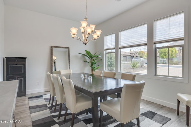 10886 N 137th St, Scottsdale, AZ 85259 - dining space featuring baseboards, light wood-style floors, and a chandelier