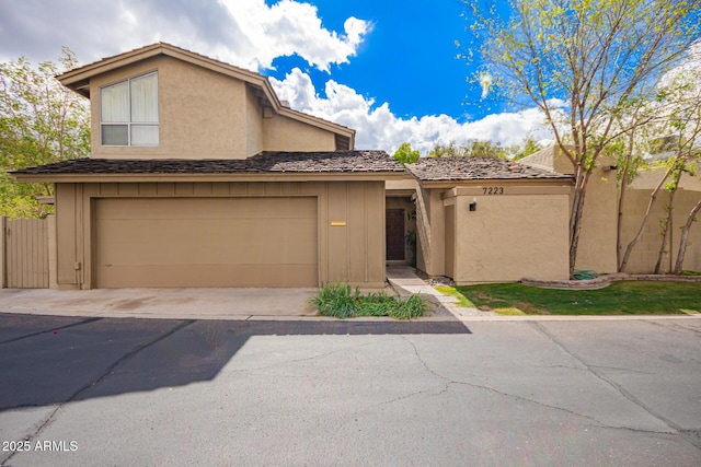 multi unit property featuring fence, driveway, and stucco siding