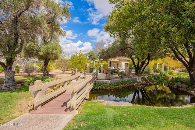 surrounding community featuring a lawn and a water view