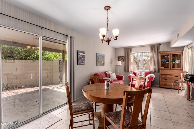 dining area with light tile patterned floors, visible vents, and a chandelier