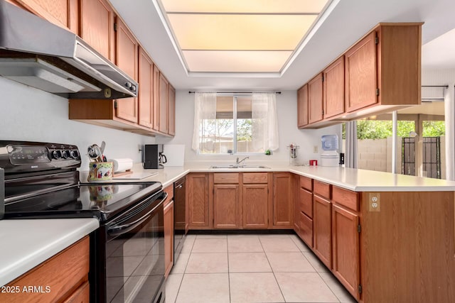 kitchen with under cabinet range hood, black appliances, a peninsula, and light countertops