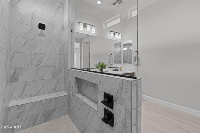 20209 W San Miguel Ave, Litchfield Park, AZ 85340 - bathroom with a tile shower, baseboards, and wood finished floors