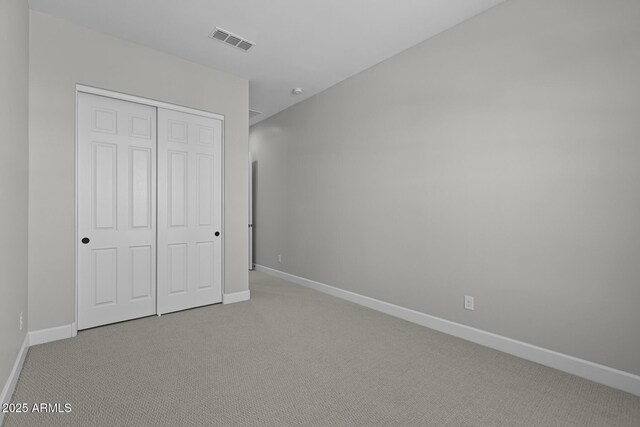 20209 W San Miguel Ave, Litchfield Park, AZ 85340 - unfurnished bedroom featuring light carpet, baseboards, and a closet